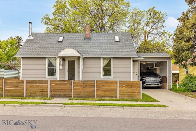 209 N 3rd, Bozeman, MT 59715 - view of front of home featuring a fenced front yard, driveway, roof with shingles, a chimney, and an attached garage