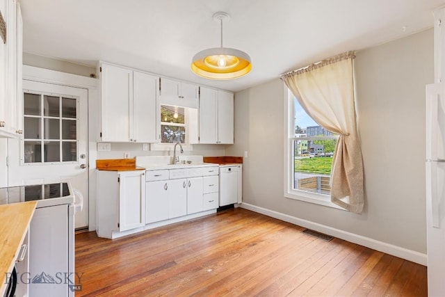 209 N 3rd, Bozeman, MT 59715 - kitchen with baseboards, light wood-type flooring, white cabinets, butcher block countertops, and range with electric stovetop