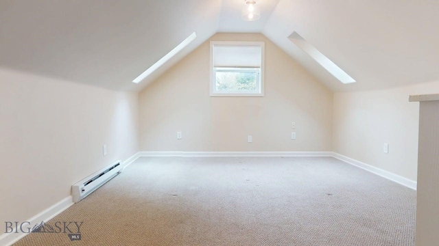 209 N 3rd, Bozeman, MT 59715 - bonus room featuring a skylight, a baseboard radiator, carpet flooring, vaulted ceiling, and baseboards