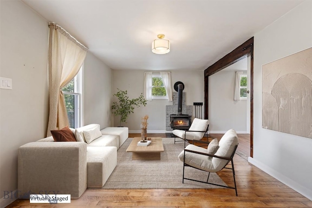 209 N 3rd, Bozeman, MT 59715 - living room with a wood stove, wood finished floors, and baseboards