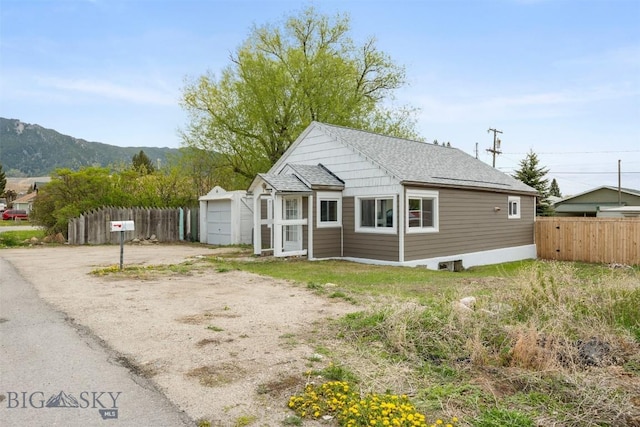 2422 Pine St, Butte, MT 59701 - view of front of home featuring driveway, a mountain view, and a shingled roof