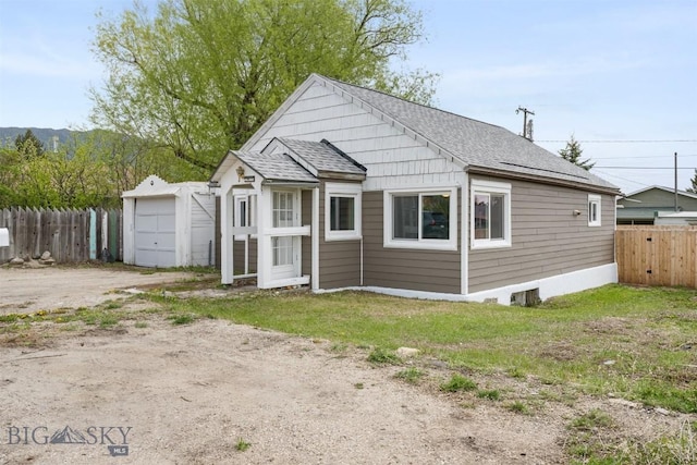 2422 Pine St, Butte, MT 59701 - view of front of home featuring roof with shingles, dirt driveway, and a garage
