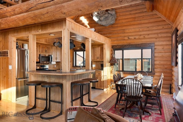 198 E River Rd, Emigrant, MT 59027 - dining room with log walls, light wood-style floors, wood ceiling with exposed beams, and healthy amount of natural light