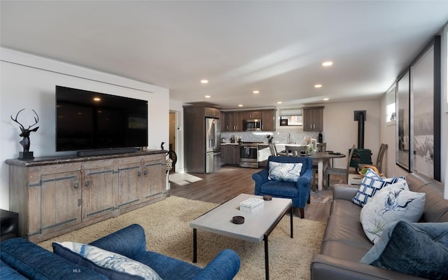 198 E River Rd, Emigrant, MT 59027 - living room featuring recessed lighting, wood finished floors, and a wood stove