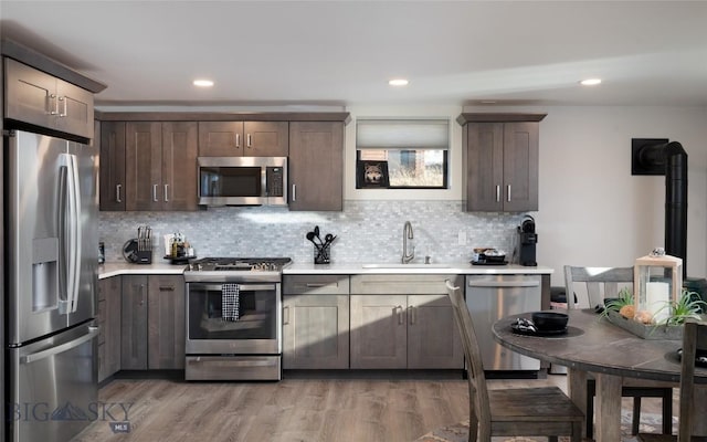 198 E River Rd, Emigrant, MT 59027 - kitchen featuring stainless steel appliances, a sink, light countertops, dark brown cabinets, and recessed lighting