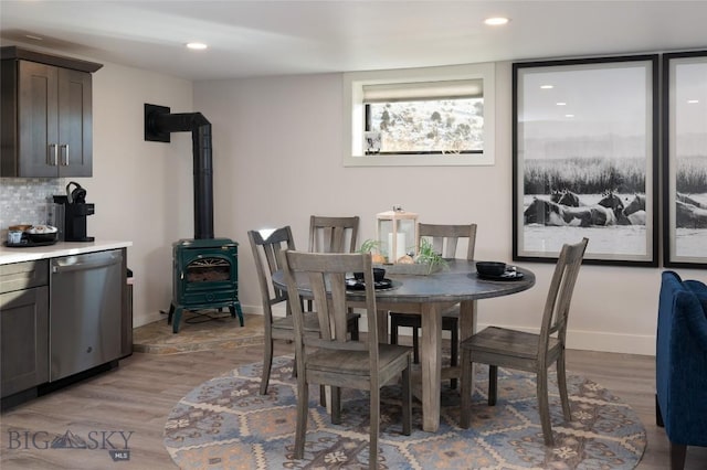 198 E River Rd, Emigrant, MT 59027 - dining space featuring light wood-type flooring, a wood stove, baseboards, and recessed lighting
