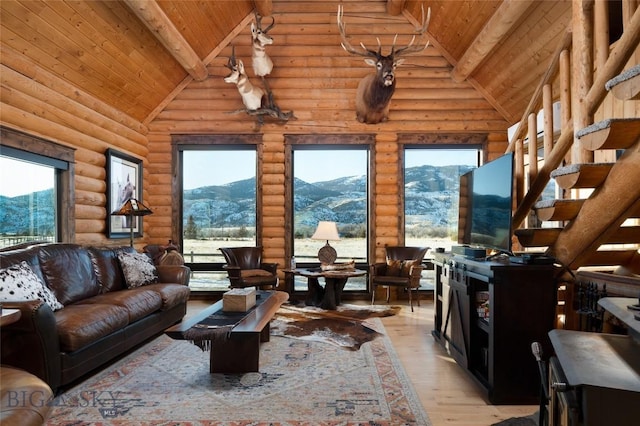 198 E River Rd, Emigrant, MT 59027 - living area featuring light wood finished floors, wood ceiling with exposed beams, high vaulted ceiling, plenty of natural light, and rustic walls