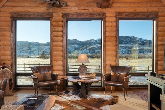 198 E River Rd, Emigrant, MT 59027 - sitting room with a mountain view, log walls, and hardwood / wood-style floors