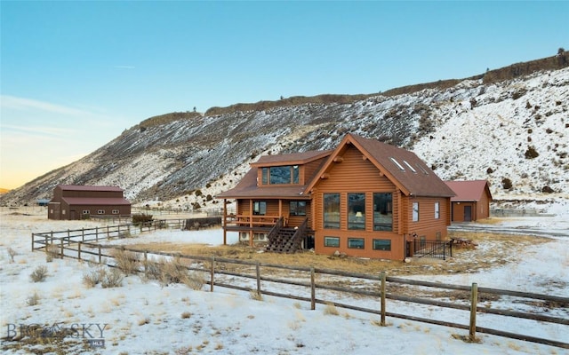 198 E River Rd, Emigrant, MT 59027 - snow covered back of property featuring log siding and a mountain view