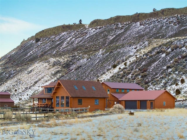 198 E River Rd, Emigrant, MT 59027 - snow covered property featuring a mountain view, a garage, and driveway