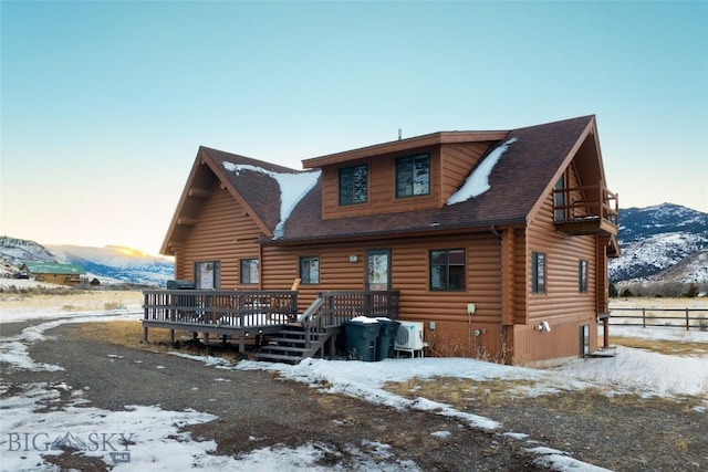 198 E River Rd, Emigrant, MT 59027 - snow covered house with a deck with mountain view, log exterior, and a shingled roof