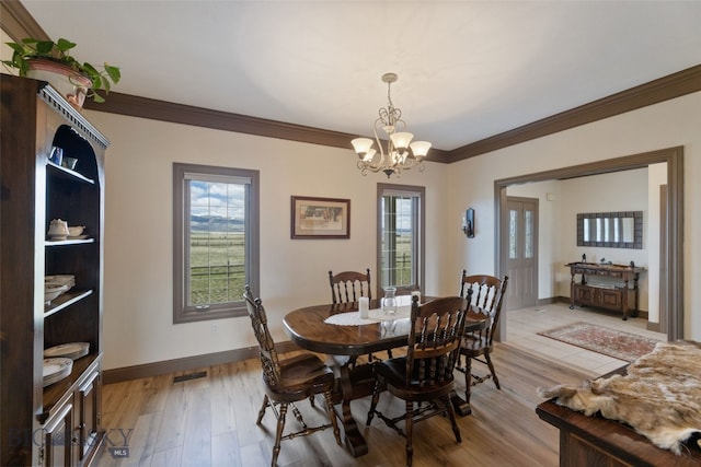 106 Lonesome Dove Rd, Cameron, MT 59720 - dining space with ornamental molding, a chandelier, baseboards, and light wood-type flooring