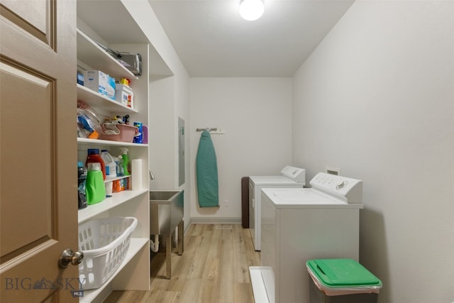 106 Lonesome Dove Rd, Cameron, MT 59720 - laundry room with washer and clothes dryer, light wood-style floors, and electric panel