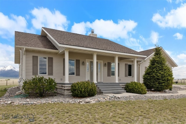 106 Lonesome Dove Rd, Cameron, MT 59720 - view of front facade featuring a chimney, covered porch, a front lawn, and roof with shingles