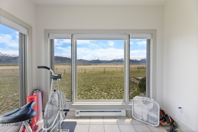 106 Lonesome Dove Rd, Cameron, MT 59720 - workout area featuring baseboard heating, a mountain view, tile patterned floors, and plenty of natural light