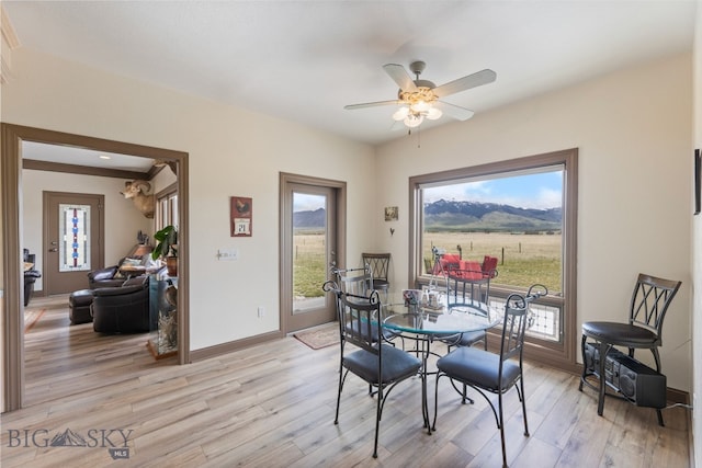 106 Lonesome Dove Rd, Cameron, MT 59720 - dining area with light wood-style flooring, a ceiling fan, and baseboards