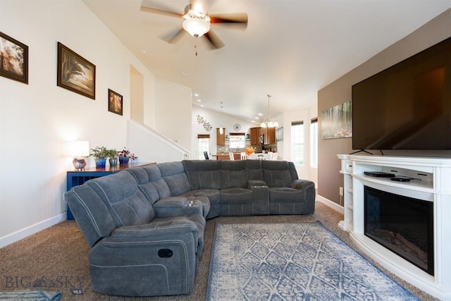 2008 Avocet Ct, Belgrade, MT 59714 - carpeted living area with ceiling fan, baseboards, a glass covered fireplace, a chandelier, and vaulted ceiling