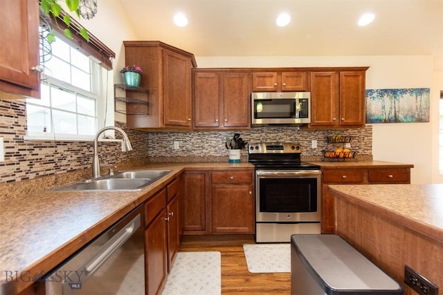 2008 Avocet Ct, Belgrade, MT 59714 - kitchen with appliances with stainless steel finishes, a sink, light wood-style floors, backsplash, and recessed lighting