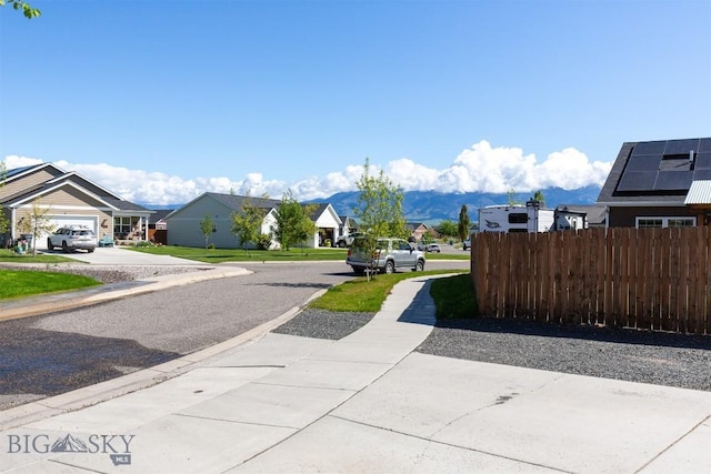 2008 Avocet Ct, Belgrade, MT 59714 - view of asphalt road featuring a residential view, curbs, and sidewalks