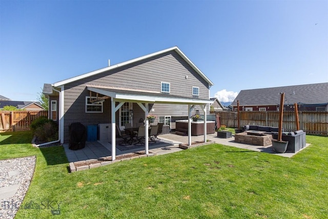 2008 Avocet Ct, Belgrade, MT 59714 - back of property featuring a hot tub, a patio, and an outdoor hangout area
