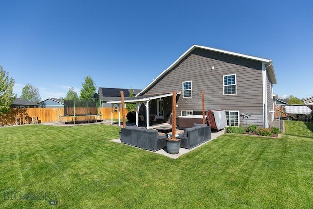 2008 Avocet Ct, Belgrade, MT 59714 - rear view of house featuring a trampoline, outdoor lounge area, and a patio area