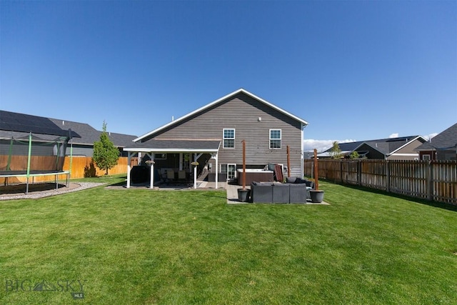 2008 Avocet Ct, Belgrade, MT 59714 - back of property featuring a trampoline, a patio, and outdoor lounge area