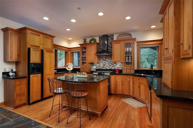 250 Petes Way, Big Sky, MT 59730 - kitchen with wall chimney range hood, a sink, high end appliances, plenty of natural light, and recessed lighting