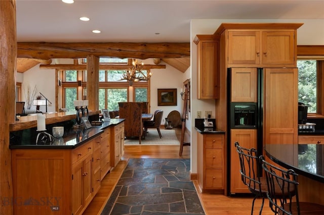 250 Petes Way, Big Sky, MT 59730 - kitchen featuring recessed lighting, paneled built in fridge, wood finished floors, a chandelier, and brown cabinets
