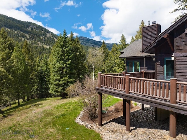 250 Petes Way, Big Sky, MT 59730 - view of yard with a deck with mountain view and a view of trees