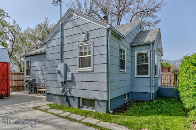 923 W Clark St, Livingston, MT 59047 - view of side of home featuring a chimney and a shingled roof