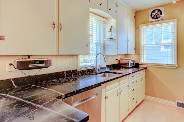 923 W Clark St, Livingston, MT 59047 - kitchen with a sink, stainless steel dishwasher, dark countertops, and baseboards