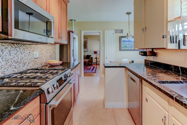 923 W Clark St, Livingston, MT 59047 - kitchen featuring appliances with stainless steel finishes, tasteful backsplash, and hanging light fixtures