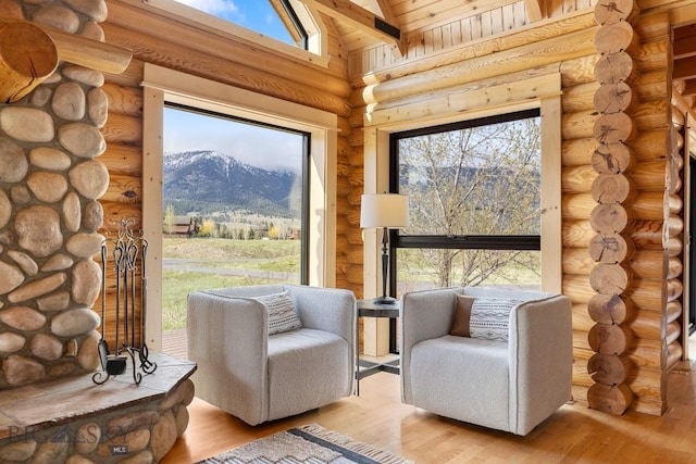 1266 Ousel Falls Rd, Big Sky, MT 59716 - living area with wood finished floors, lofted ceiling, a mountain view, and plenty of natural light