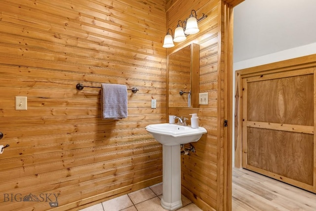 1266 Ousel Falls Rd, Big Sky, MT 59716 - bathroom featuring wood walls, tile patterned flooring, and a sink
