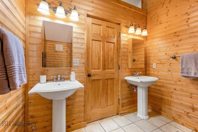 1266 Ousel Falls Rd, Big Sky, MT 59716 - bathroom featuring wood walls, tile patterned flooring, and a sink