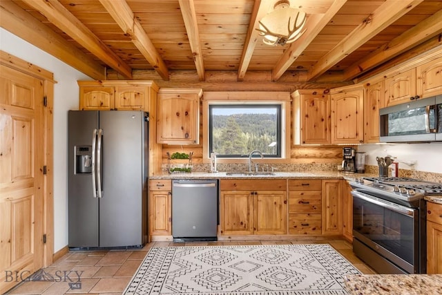 1266 Ousel Falls Rd, Big Sky, MT 59716 - kitchen featuring stainless steel appliances, a sink, light stone countertops, light brown cabinetry, and wood ceiling with exposed beams