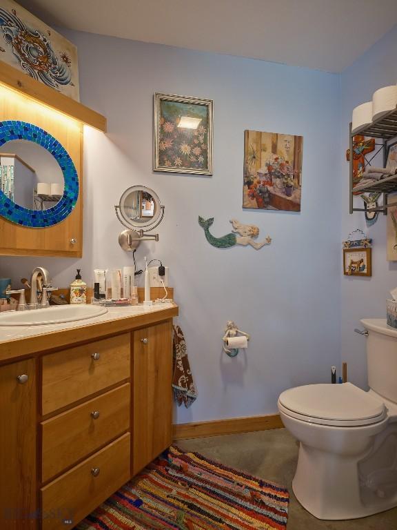 2178 Little Bear Rd, Gallatin Gateway, MT 59730 - bathroom featuring toilet, vanity, and baseboards
