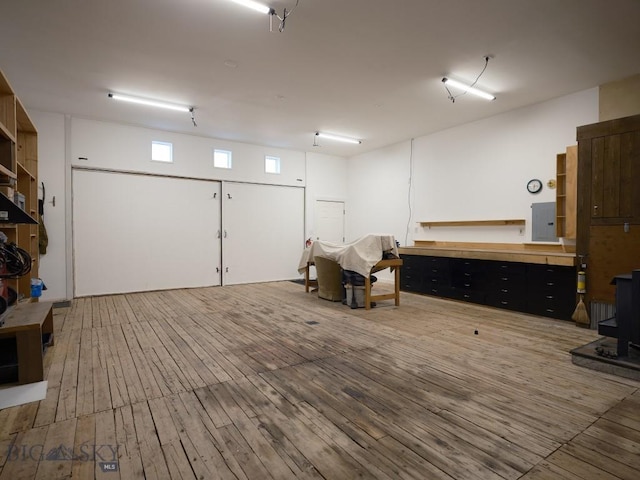 2178 Little Bear Rd, Gallatin Gateway, MT 59730 - miscellaneous room featuring electric panel, a wood stove, and hardwood / wood-style floors