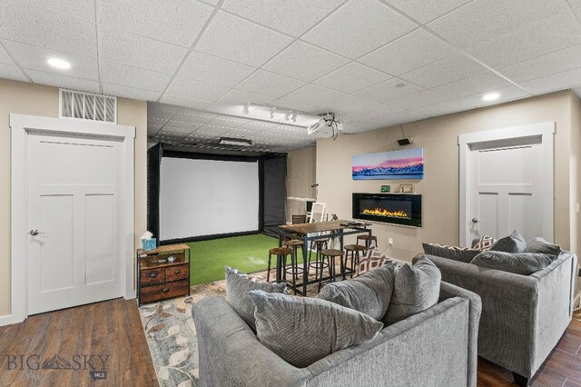 145 Cushing Ln, Manhattan, MT 59741 - home theater with a glass covered fireplace, a drop ceiling, wood finished floors, and recessed lighting