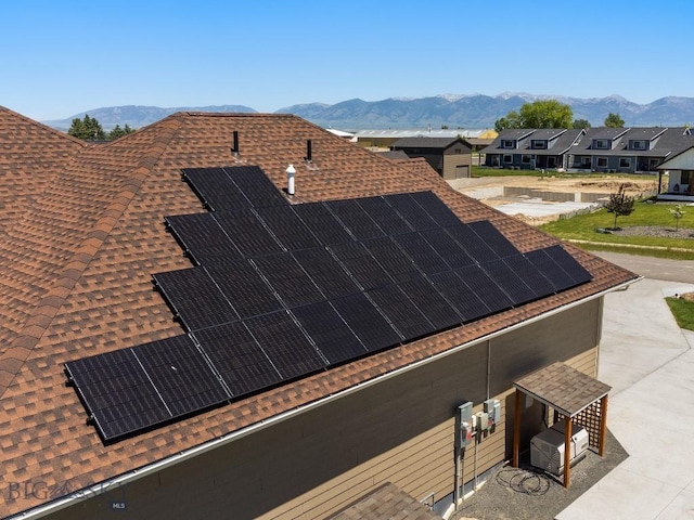 145 Cushing Ln, Manhattan, MT 59741 - exterior view of a shingled roof, a mountain backdrop, and a residential view