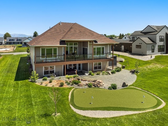 145 Cushing Ln, Manhattan, MT 59741 - rear view of house with an area to practice putting, a patio area, and a lawn