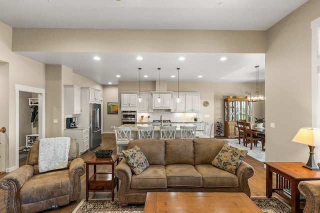 145 Cushing Ln, Manhattan, MT 59741 - living area with wood finished floors, a chandelier, and recessed lighting