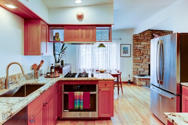 425 N 7th St, Livingston, MT 59047 - kitchen featuring appliances with stainless steel finishes, a sink, light wood finished floors, light stone counters, and recessed lighting
