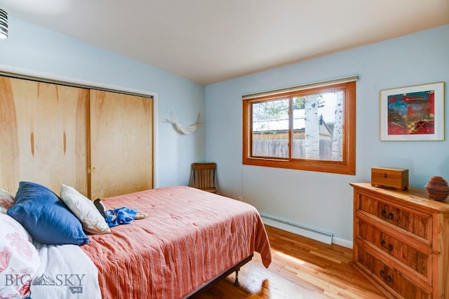 425 N 7th St, Livingston, MT 59047 - bedroom with baseboard heating, wood finished floors, baseboards, and a closet