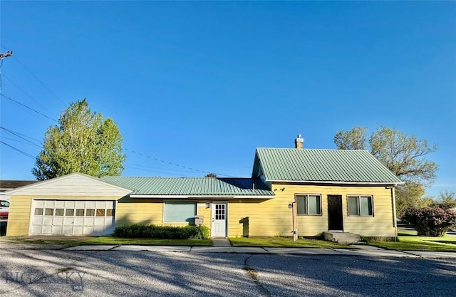 15 S Colorado St, Dillon, MT 59725 - ranch-style house with a garage, a chimney, and metal roof