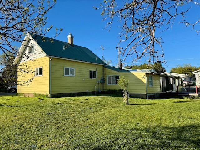 15 S Colorado St, Dillon, MT 59725 - back of house featuring a yard, a chimney, and metal roof
