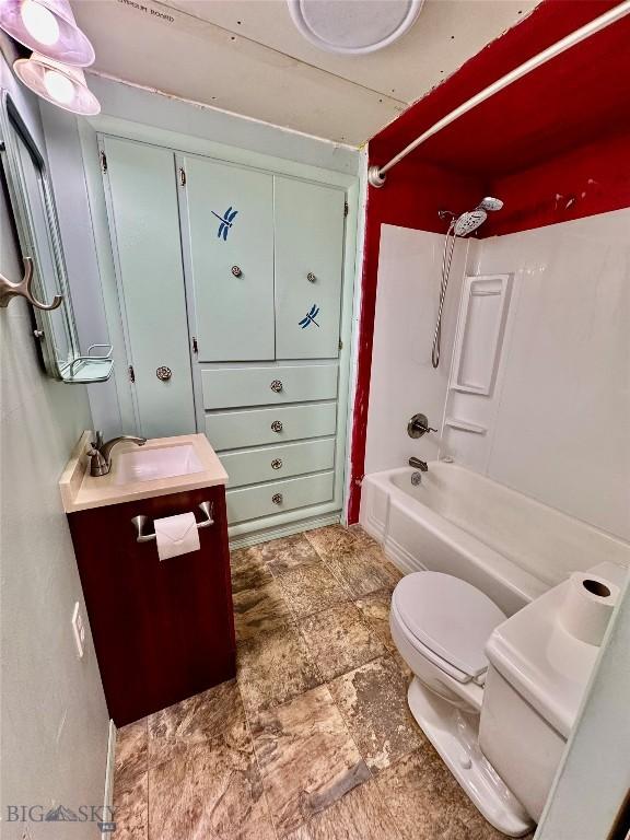 15 S Colorado St, Dillon, MT 59725 - bathroom featuring vanity, toilet, shower / bath combination, and stone finish flooring