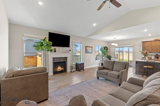 1711 Shelby Ave, Belgrade, MT 59714 - living room with lofted ceiling, light wood finished floors, ceiling fan, a glass covered fireplace, and recessed lighting