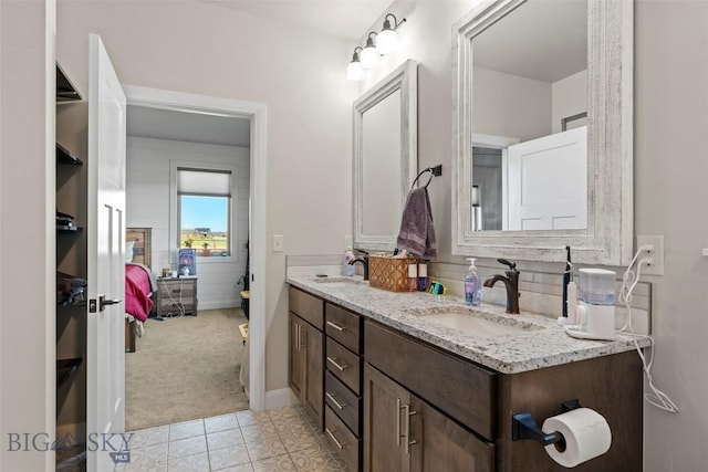 1711 Shelby Ave, Belgrade, MT 59714 - bathroom featuring double vanity, ensuite bathroom, and tile patterned floors