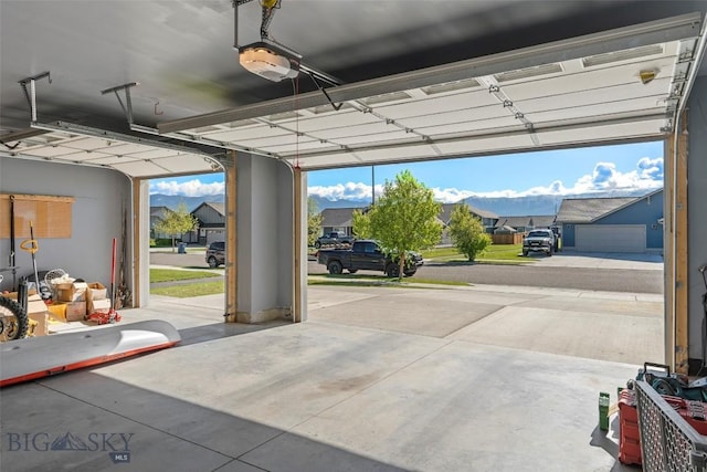 1711 Shelby Ave, Belgrade, MT 59714 - garage with a garage door opener and a residential view